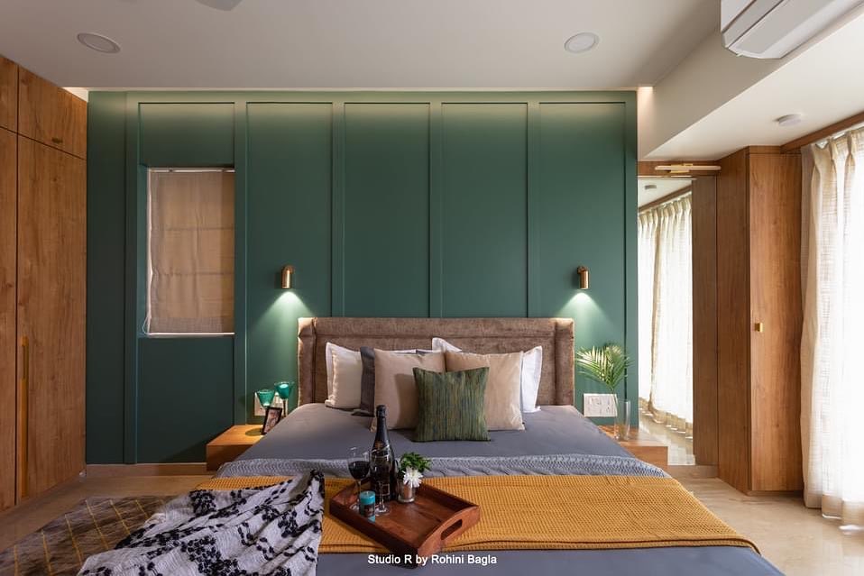 4. Sage Green Canopy with Macrame Accents and Rattan Lighting