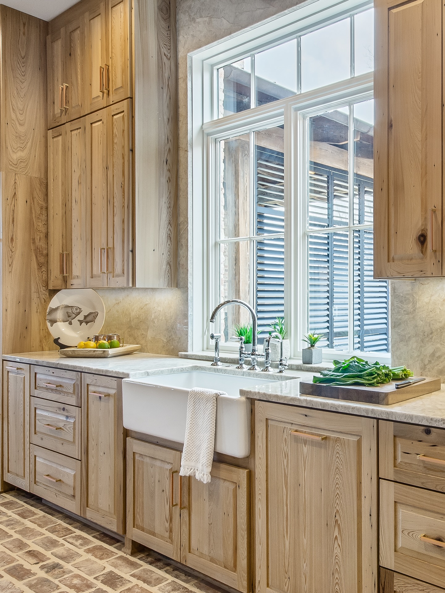 9. the Antique Copper Pot Rack with Vintage Glass Jars Above the Farmhouse Sink