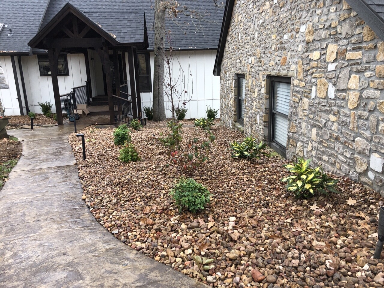 8. River Rock Mosaic with Embedded Driftwood Accents