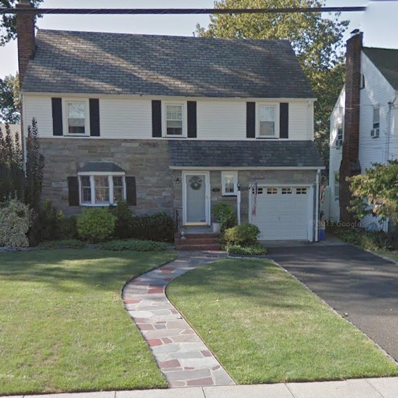 17. Lush Ferns and Stone Mosaic Pathway Leading to a Rustic Wooden Arch
