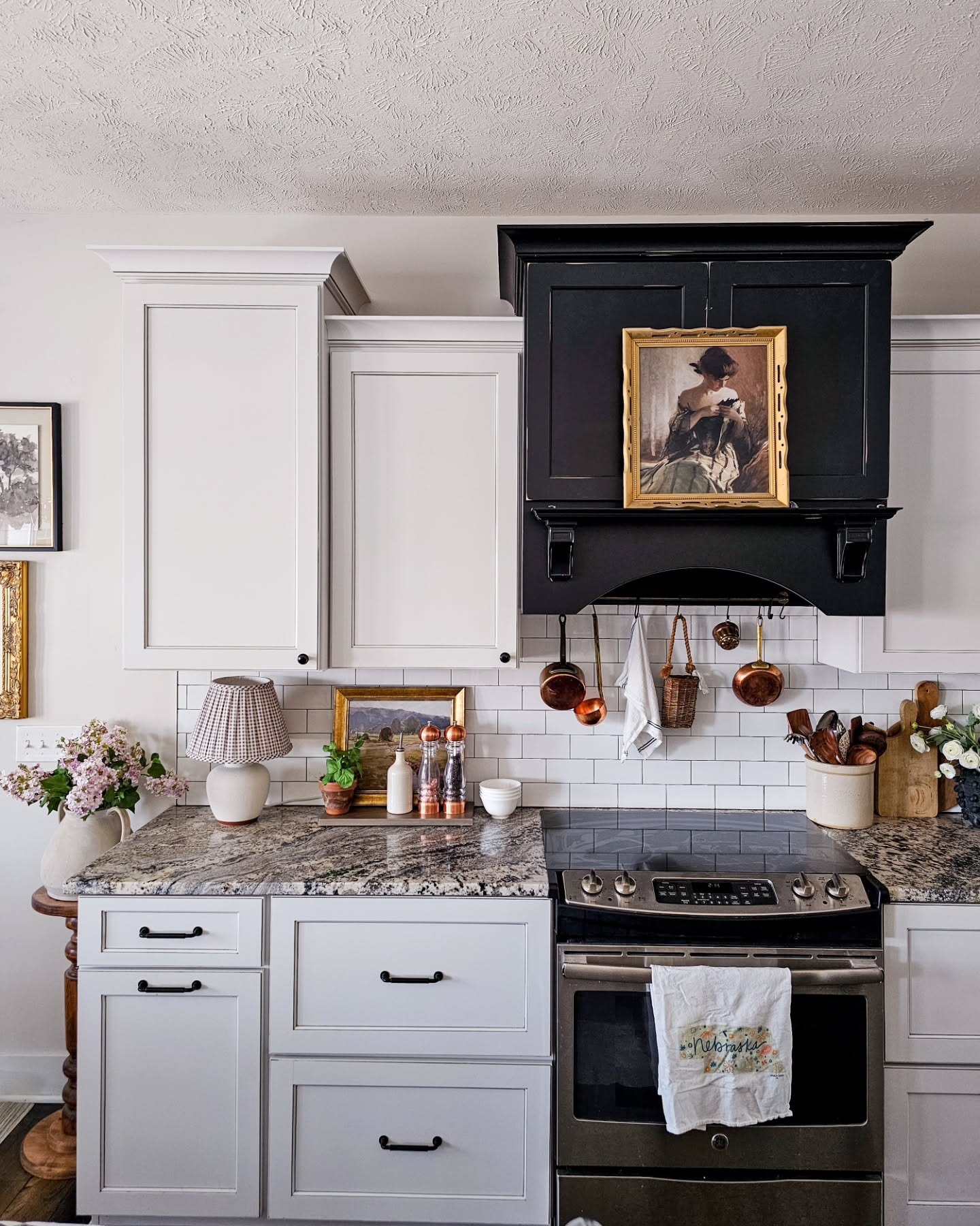 29. Glossy Black Cabinets Meet Geometric White Backsplash In a Monochromatic Dance