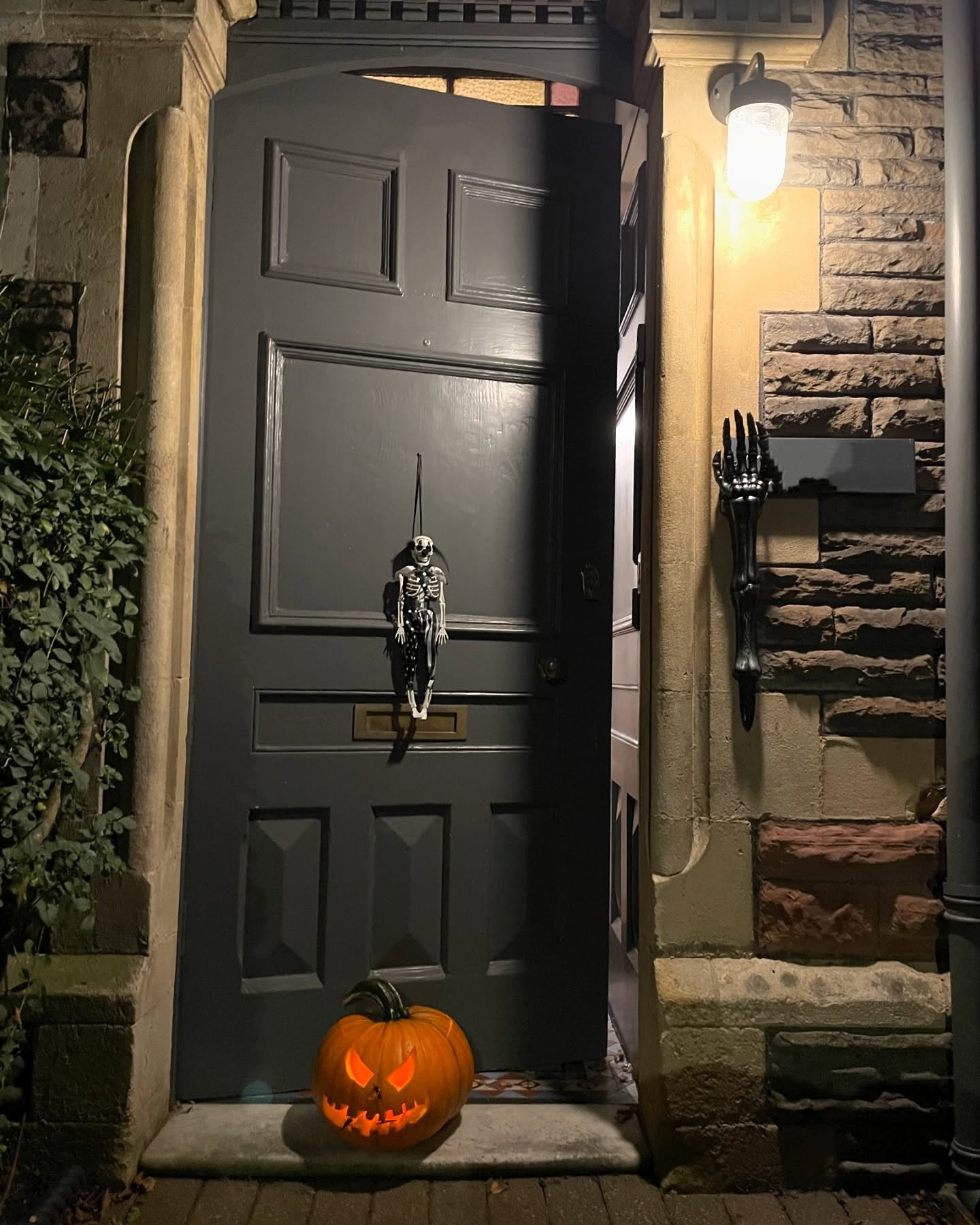 4. Spooky Silhouette Of Dancing Skeletons with a Crescent Moon Backdrop