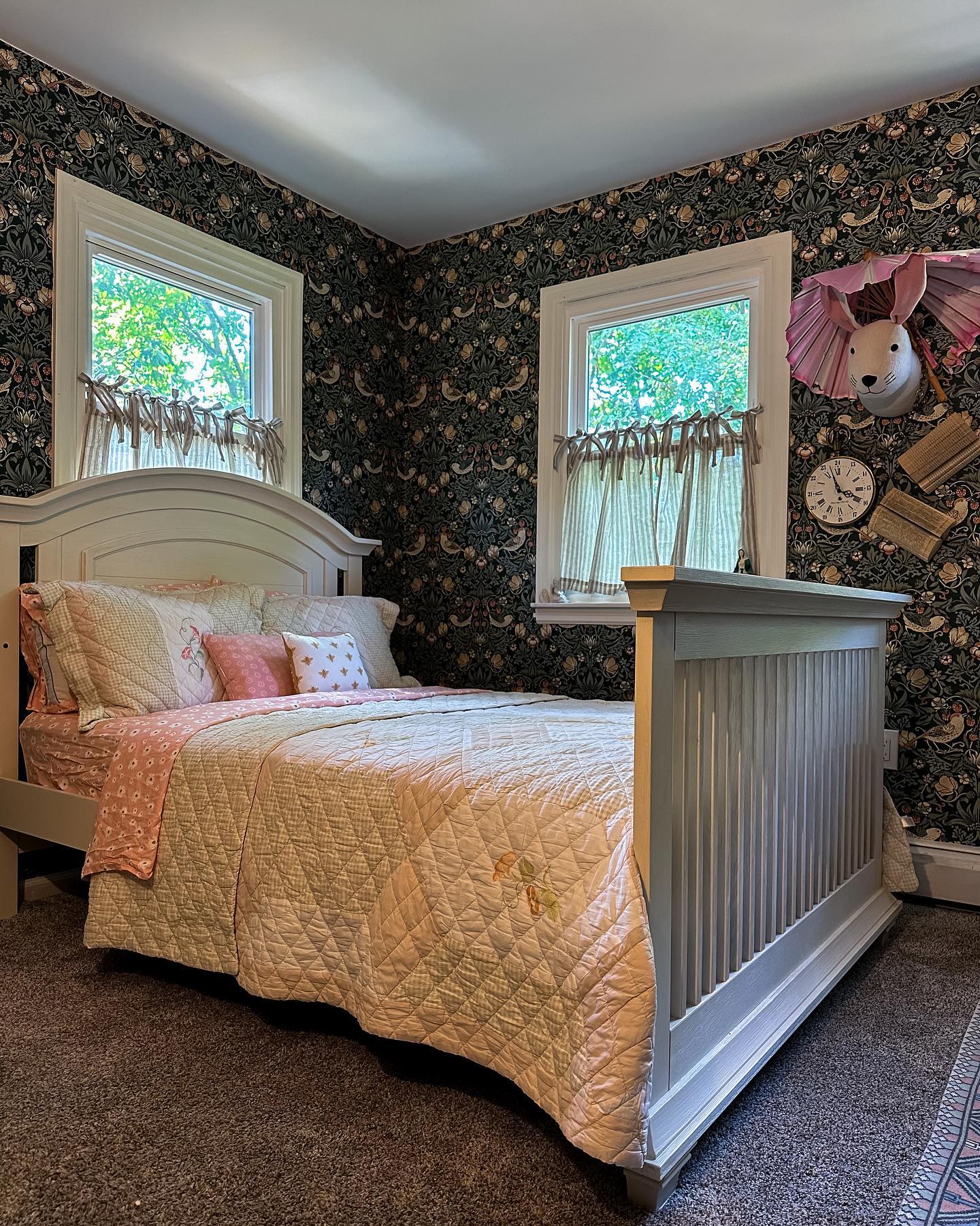 15. Wicker Canopy Bed with Moss Green Quilt and Wildflower Garland Accents