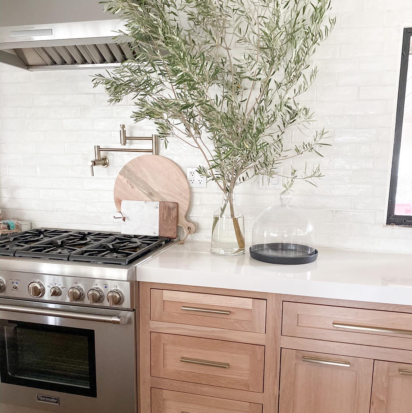 21. White Marble Herringbone with Brass Accents: a Timeless Kitchen Transformation