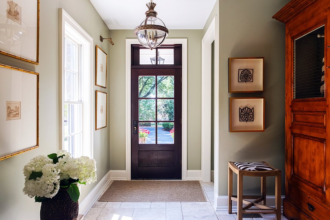 33. Velvet Crimson Armchair with Golden Accents Amidst Monochrome Elegance
