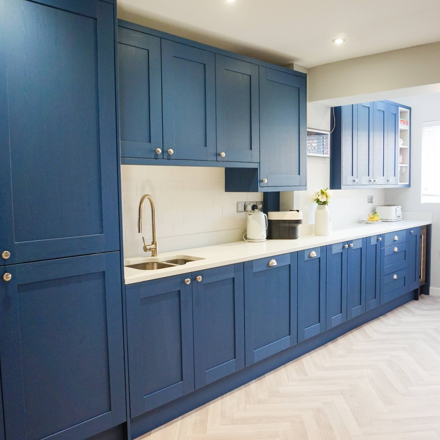 30. Vibrant Turquoise Cabinets with Geometric White Tile Backsplash